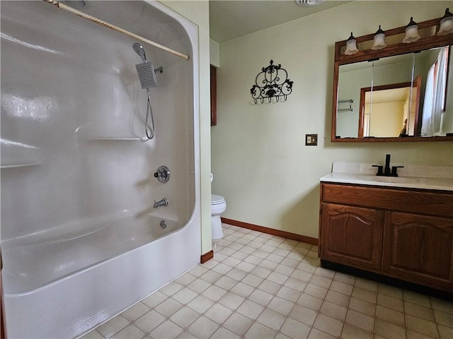 bathroom featuring vanity, toilet, baseboards, and shower / bathtub combination