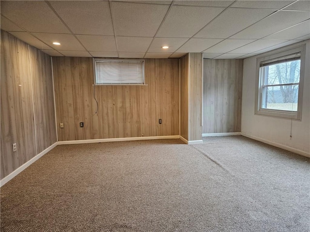 spare room with wooden walls, baseboards, a drop ceiling, carpet floors, and recessed lighting