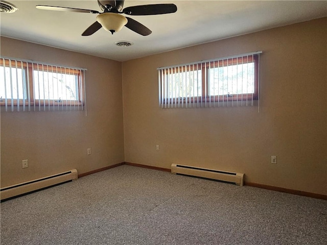 carpeted empty room with a baseboard heating unit, baseboards, visible vents, and baseboard heating