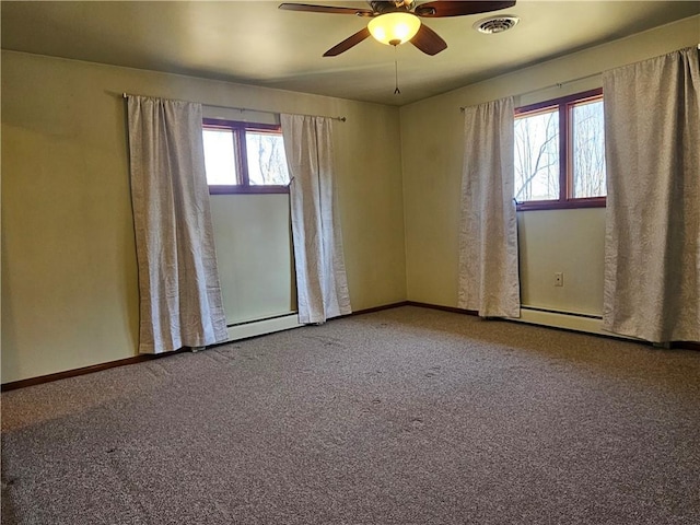 carpeted spare room featuring a baseboard heating unit, visible vents, baseboards, and ceiling fan