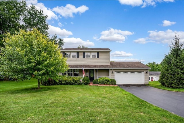 traditional home featuring a garage, driveway, and a front lawn