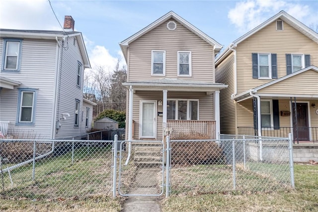 view of front of property with a fenced front yard, a gate, a front lawn, and a porch