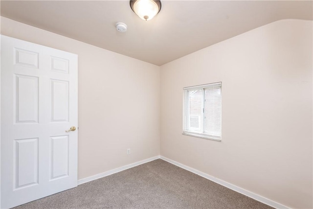 carpeted empty room with baseboards