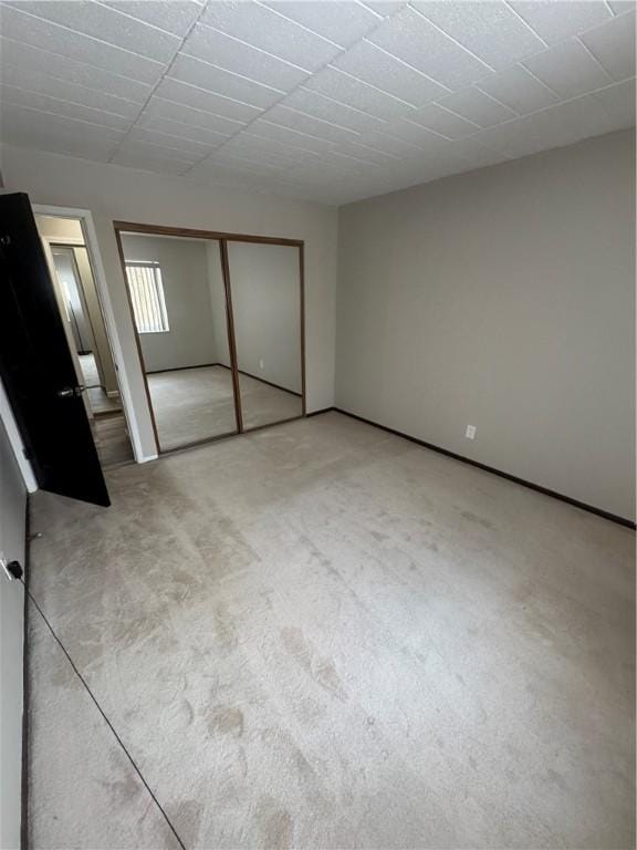 unfurnished bedroom featuring a closet and carpet