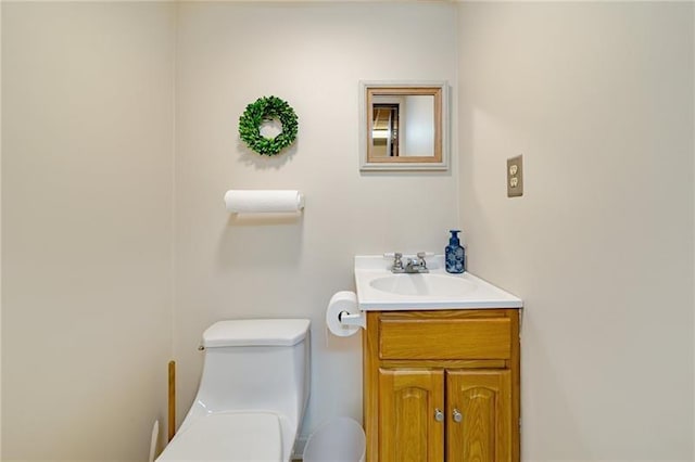 half bathroom with toilet and vanity