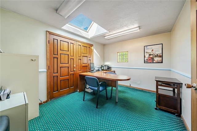 carpeted office space featuring a textured ceiling