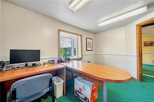 carpeted office featuring a textured ceiling