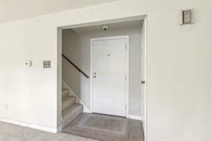 interior space featuring stairway and baseboards