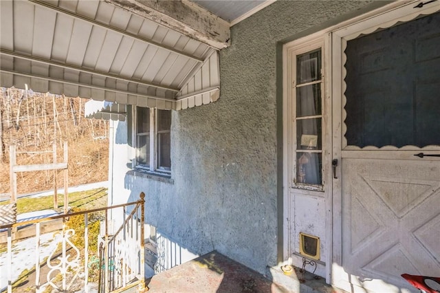 entrance to property featuring stucco siding