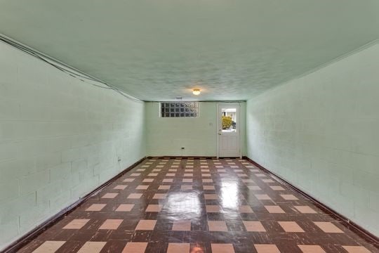 empty room featuring concrete block wall