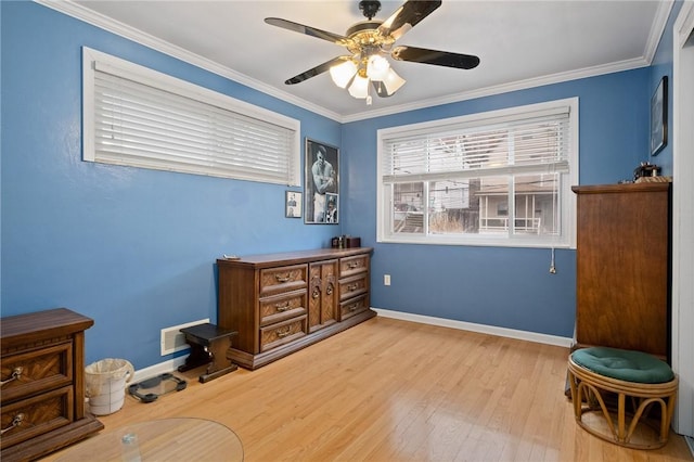 sitting room with a ceiling fan, baseboards, ornamental molding, and wood finished floors