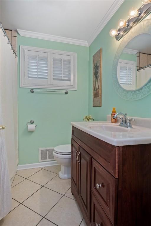 bathroom with crown molding, visible vents, toilet, vanity, and tile patterned flooring