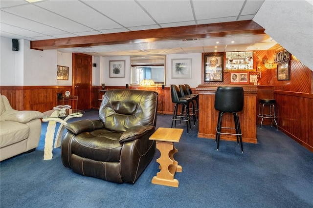 bar with a drop ceiling, carpet floors, wood walls, wainscoting, and a dry bar