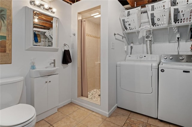 laundry room with laundry area, baseboards, washer and dryer, a sink, and light tile patterned flooring