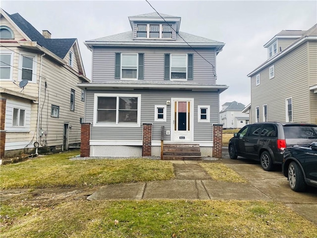 american foursquare style home with entry steps and a front yard