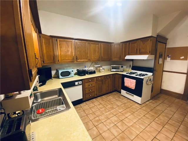 kitchen with white appliances, light countertops, a sink, and under cabinet range hood