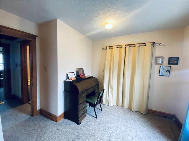 home office with carpet floors, a textured ceiling, and baseboards