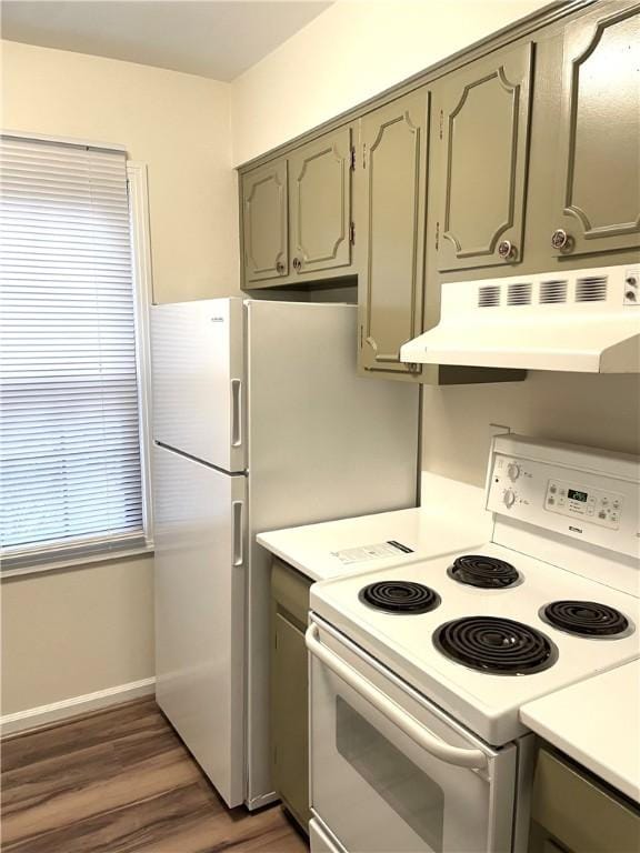 kitchen with gray cabinetry, under cabinet range hood, wood finished floors, light countertops, and white range with electric cooktop