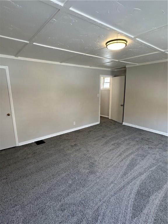 unfurnished room with carpet flooring and baseboards