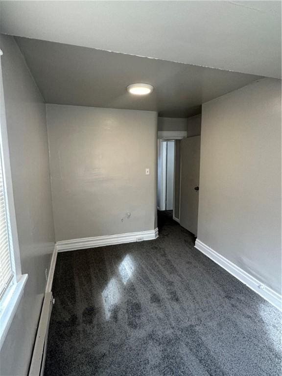 spare room featuring baseboards and baseboard heating