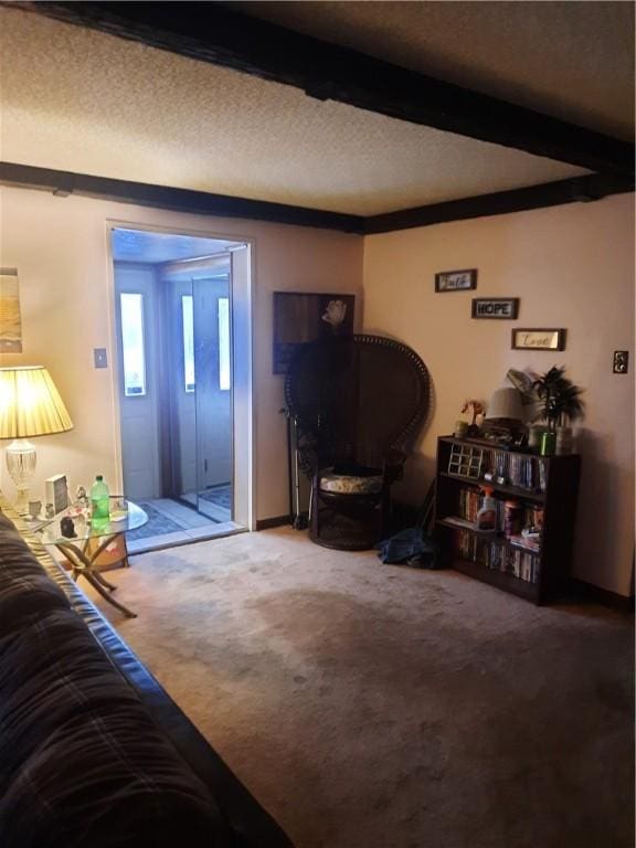 carpeted living area featuring a textured ceiling and beamed ceiling