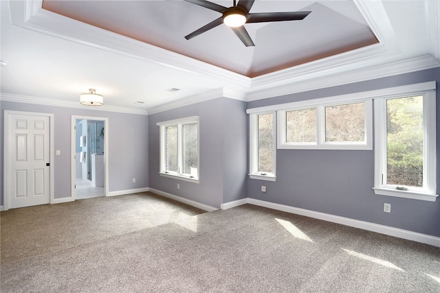 spare room with baseboards, carpet, and crown molding