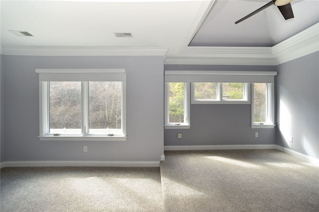 empty room with baseboards, carpet, visible vents, and crown molding