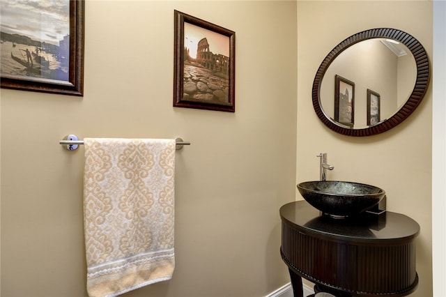 bathroom with baseboards and a sink