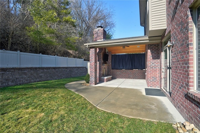 view of yard with fence and a patio