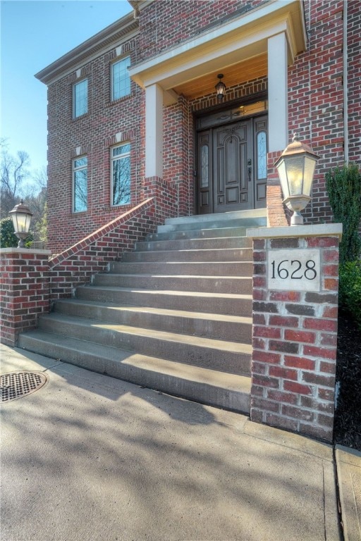 property entrance featuring brick siding