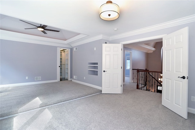 spare room featuring ornamental molding, carpet, and baseboards