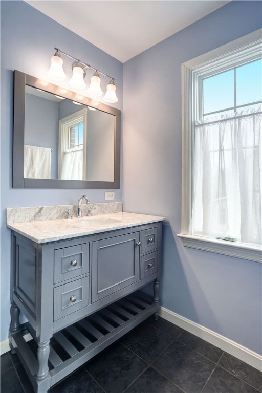 bathroom featuring tile patterned floors, vanity, and baseboards