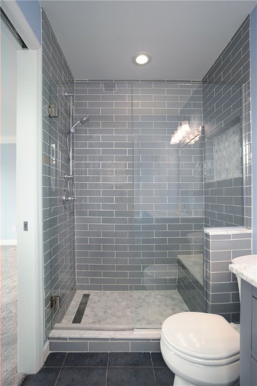 full bathroom featuring toilet, a shower stall, vanity, and tile patterned floors