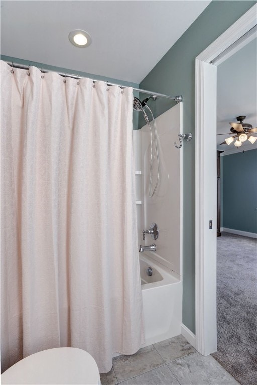 full bathroom with shower / bath combo, toilet, and baseboards