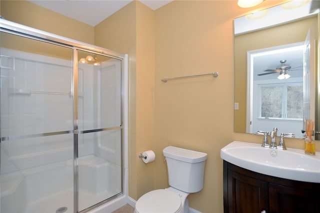 bathroom with toilet, a shower stall, and vanity