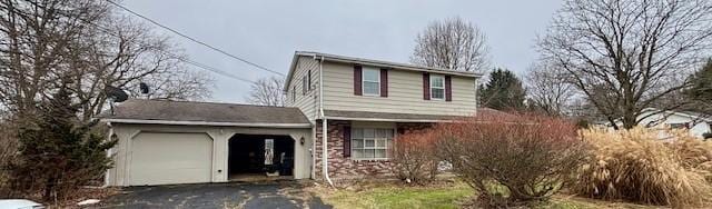 traditional-style home featuring a garage and driveway