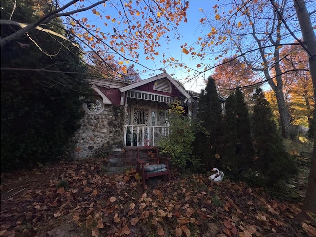 back of house with stone siding