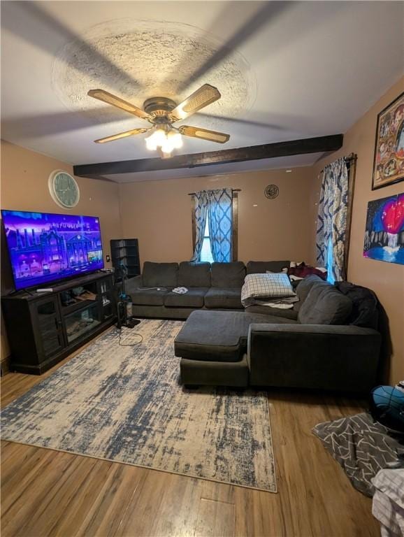 living area featuring a ceiling fan, a textured ceiling, and wood finished floors