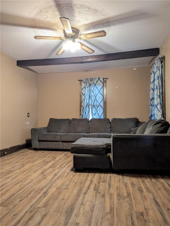 living room with wood finished floors and ceiling fan