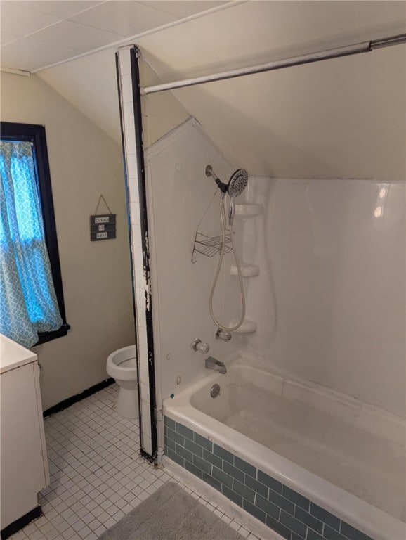 bathroom with lofted ceiling, toilet, vanity, tile patterned floors, and shower / bath combination