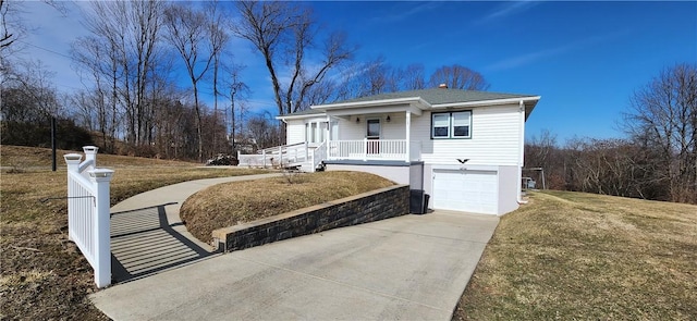 view of front of property featuring a garage, concrete driveway, a porch, and a front lawn