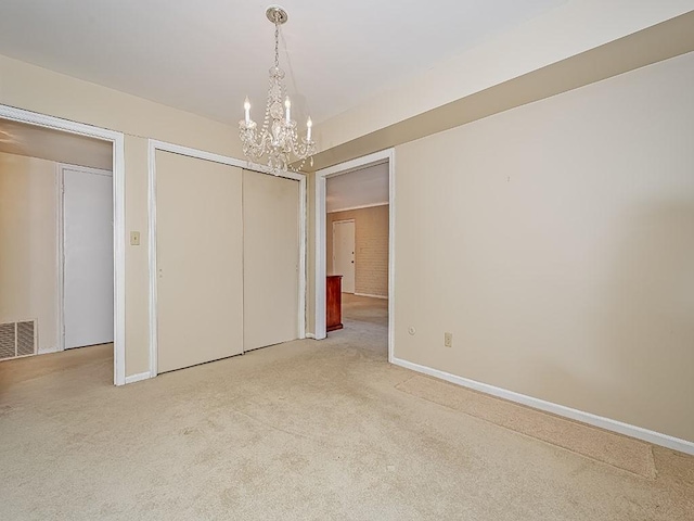 unfurnished bedroom featuring a closet, light colored carpet, visible vents, and baseboards