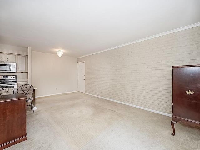 living room featuring brick wall, light carpet, and baseboards