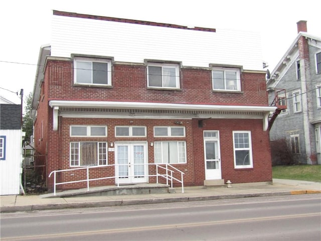 view of front of house with french doors and brick siding