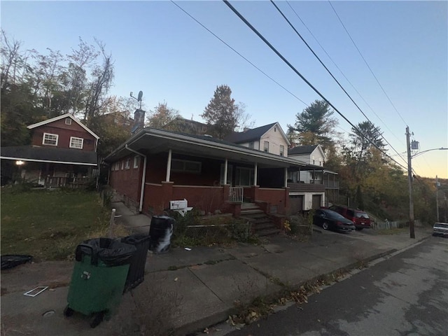 view of front of property featuring a porch and concrete driveway