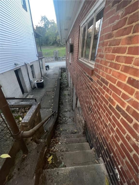 view of side of home featuring brick siding