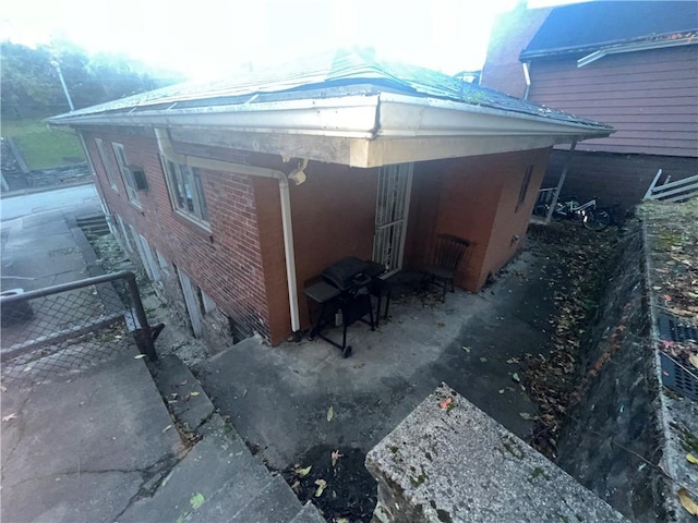 view of property exterior with brick siding