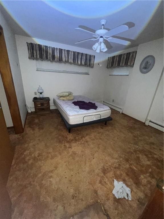 carpeted bedroom featuring baseboard heating and a ceiling fan