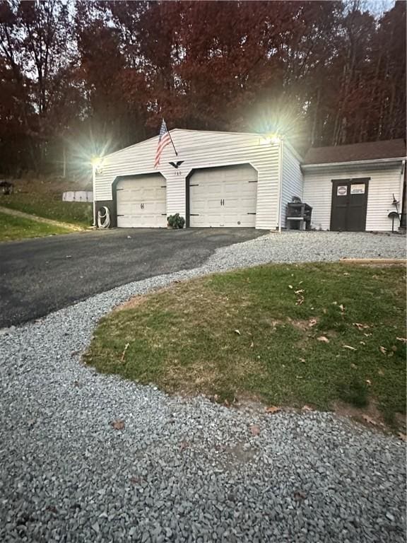 garage with aphalt driveway