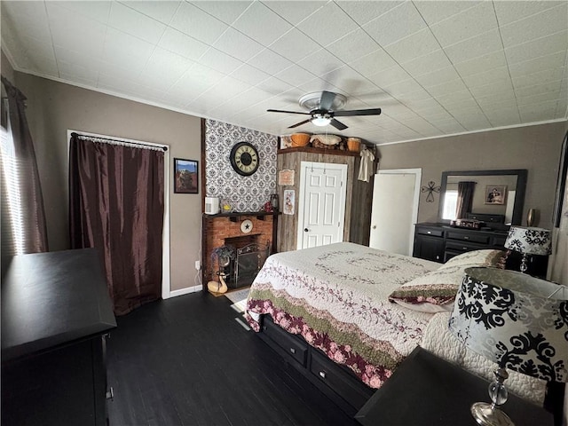 bedroom with multiple windows, a ceiling fan, dark wood-style flooring, and ornamental molding